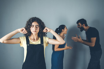 Wall Mural - crying girl with parents dispute in home