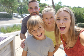 Portrait of cheerful family on summer vacation