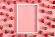 Strawberries on pink background. Blank frame for text, strawberries berries pattern. Creative food concept. Flat lay, top view, copy space