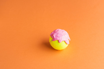 Wall Mural - Tennis ball with pink paint on orange