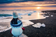 Woman Enjoying Diamond Beach Sunset In Iceland
