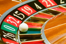 Roulette Table In Casino, With Many Games And Slots, Roulette Wheel In The Foreground.