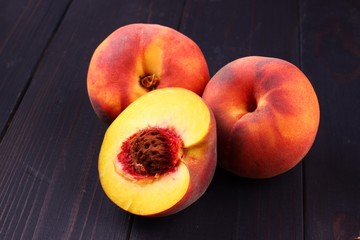 Poster - Peach on a dark wooden background