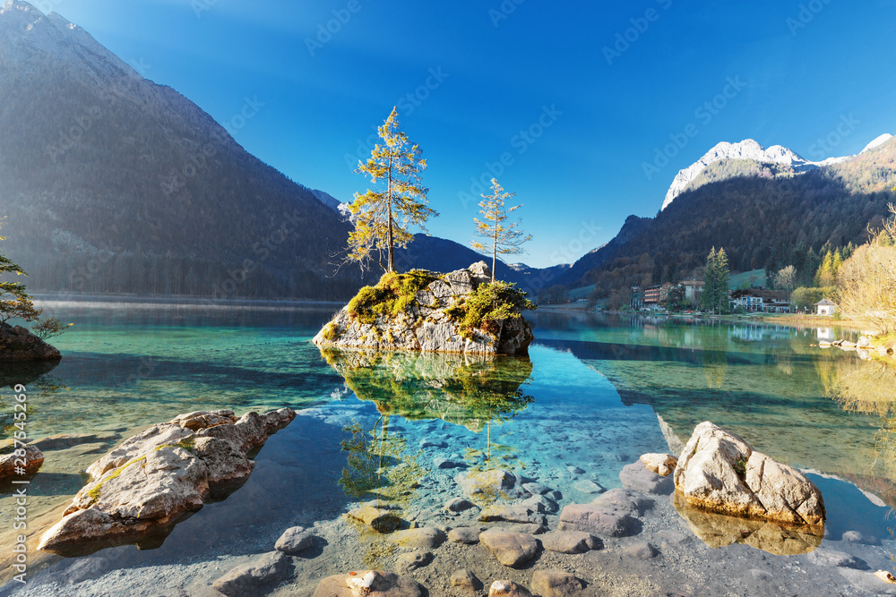 Lake Hintersee in Germany, Bavaria, National Park Ramsau in Alps. Beautiful autumnal Alpine landscape, amazing light during sunrise. Incredible seasonal autumn scenery. Famous landmark in Germany. - obrazy, fototapety, plakaty 
