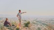 © raisondtre - Couple Man and Woman on top of mountain enjoying beautiful landscape cityscape Athens Greece on background. Tourists relax on hill Athens in summer. Famous Athens city in Europe. Lifestyle concept.