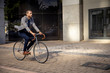 © Wavebreak Media - Young professional man riding a bike in a city