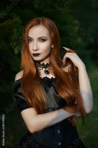 Portrait Of A Red Haired Witch Twisting A Long Lock Of Hair On Her
