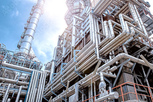 Fotomural Oil and gas refinery plant form industry petroleum zone,Refinery equipment pipeline steel and oil storage tank at sunrise
