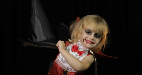 Wall Mural - Dracula child. Girl with halloween make-up. Vampire kid with blood on her face