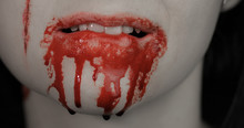 Bloody Mouth And Teeth Of Girl. Vampire Halloween Makeup With Dripping Blood