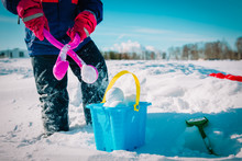 Child Making Snowballs In Winter Nature, Kids Play Outdoors
