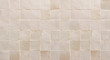 Old retro beige ceramic tile texture background. Beige square tiled wall.