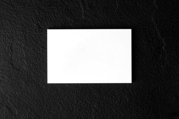 Wall Mural - White business card mock-up on a black slate background