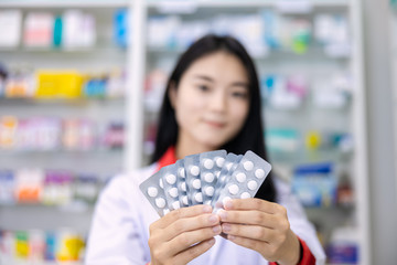 Wall Mural - asian female pharmacist in the pharmacy health care concept