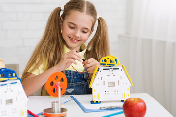 Wall Mural - Stem education. School girl constructing robot at lesson