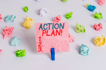 Conceptual hand writing showing Action Plan. Concept meaning proposed strategy or course of actions for certain time Colored crumpled paper empty reminder white floor clothespin