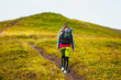 © Андрей Репетий - Woman hiker with a backpack going up the trail