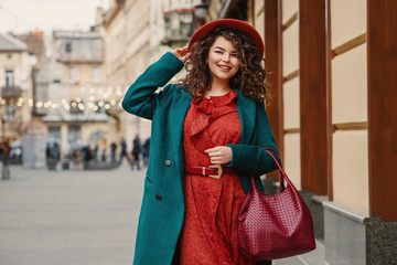 happy smiling fashionable curvy woman wearing trendy autumn outfit: orange hat, snakeskin print dres