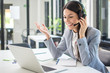 © Bojan - Beautiful young call center operator woman in headset talking to a client in office