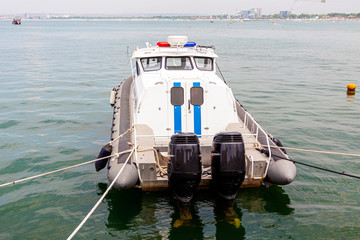 Police boat with two engines stands at the marina.