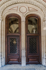 Wooden brown Front Door of a Luxurious house. Doors with glass and forged window grille