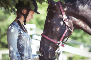 Wall Mural - Chestnut horse touchs her young owner palm with nose