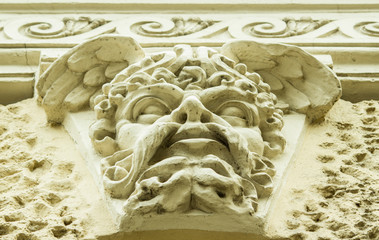 textured vintage bas-relief on the facade of the building close-up during daylight hours