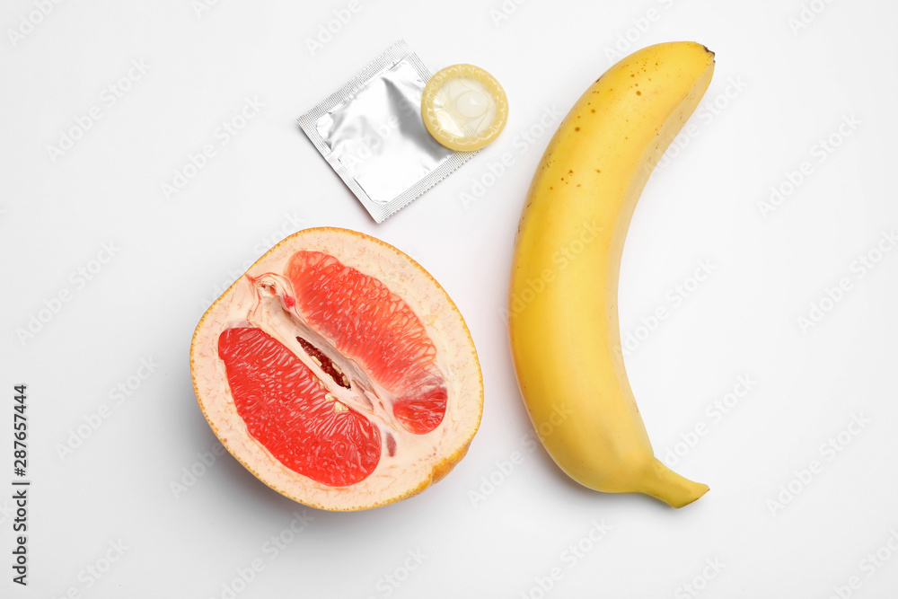 Stock-Foto Condom, cut grapefruit and banana on white background, top  view. Safe sex | Adobe Stock