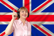 woman in headphones against the background of the national flag of Great Britain on delicate shiny silk, concept of free broadcast, music, news, podcast, horizontal, close-up, copy space