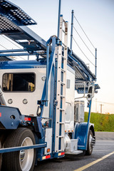 Big rig industrial car hauler semi truck standing on parking lot waiting for loading time