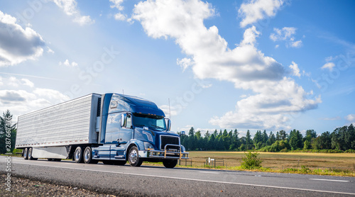 Fotomural Blue big rig semi truck with grille guard trabsporting frozen cargo in refrigera