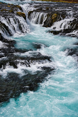 Wall Mural - bruarfoss waterfall in iceland showing it's true blue colors on a cold spring day