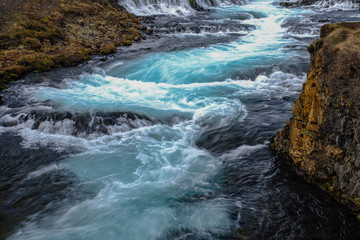 Wall Mural - bruarfoss waterfall in iceland showing it's true blue colors on a cold spring day