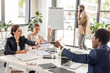 © LIGHTFIELD STUDIOS - multiethnic businesspeople in formal wear at table during conference in office