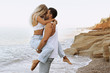 beautiful lovely couple wearing jeans,posing at summer beach