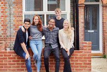 Portrait Of Group Of Smiling College Students Outside Rented Shared House