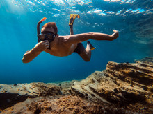 Underwater Photo Of Men Snorkeling By The Sea Reef