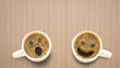 © kukiat - Three different faces coffee cup on a wooden table.