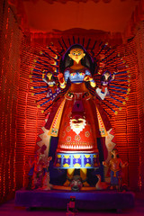 Idol of Goddess Devi Durga at a decorated puja pandal in Kolkata, West Bengal, India. Durga Puja is a famous and major religious festival of Hinduism that is celebrated throughout the world.