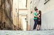 © bakharev - young couple in love walking on a street of European city. sightseeing traveler
