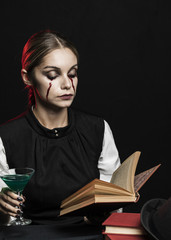 Woman with green drink reading book