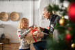 © Rido - Grandmother giving xmas present to granddaughter