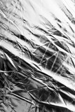Fototapeta Dmuchawce - Crumpled silver material as abstract background