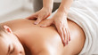 Body care. Young girl having massage, relaxing in spa salon