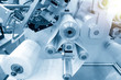 © Pixel_B - The operation of automatic plastic bag production machine with lighting effect. Close-up of the roller of the plastic bag production machine in the light blue scene.