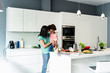 © Westend61 - Happy mother holding daughter in kitchen