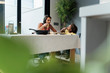 © Westend61 - Mother and daughter eating pasta at dining table