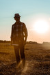 © LIGHTFIELD STUDIOS - handsome self-employed man holding rake in wheat field
