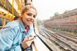 © Westend61 - Portrait of smiling young woman travelling by train