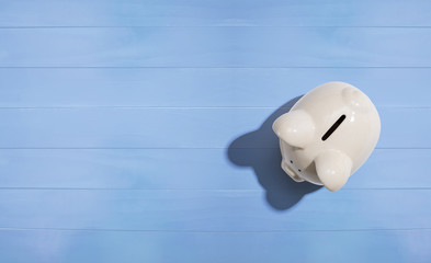 A white piggy bank overhead view flat lay